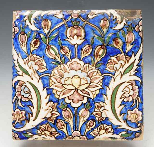 Appraisal: AN ISNIK POLYCHROME POTTERY SQUARE TILE with stylised flower decoration