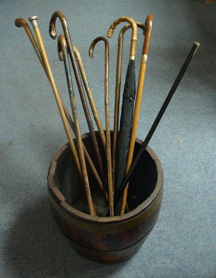 Appraisal: A brass bound umbrella stand and sundry walking sticks