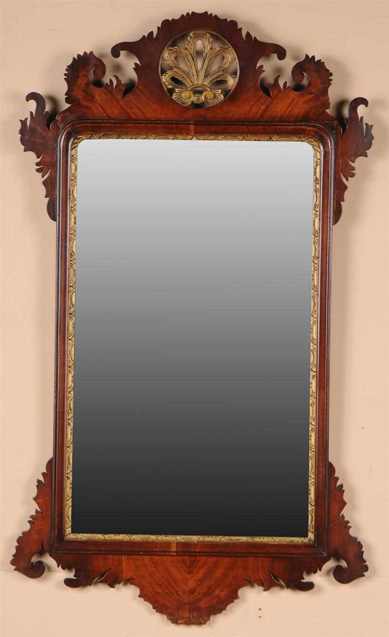 Appraisal: GEORGE II MAHOGANY AND PARCEL-GILT MIRROR The plate within leaf-tip