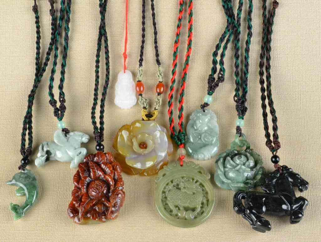 Appraisal: Chinese Carved Jade And Agate PendantsCarved to depict animals a