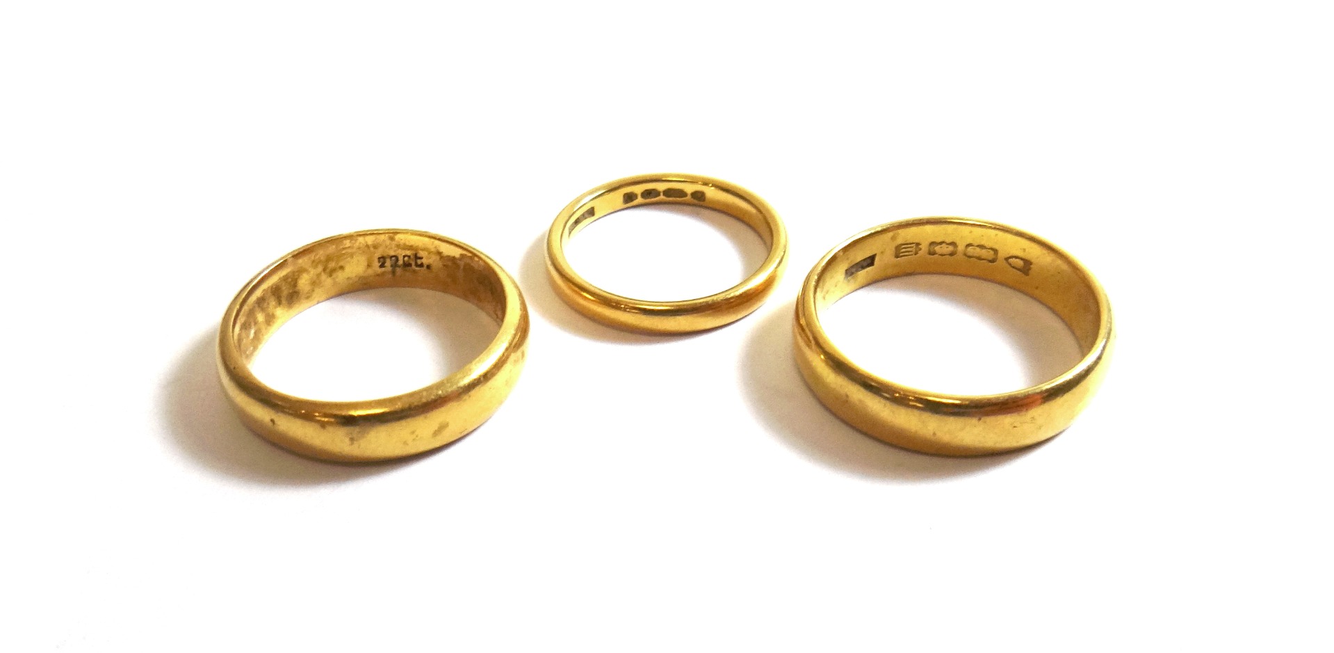 Appraisal: Two ct gold plain wedding rings and a gold plain