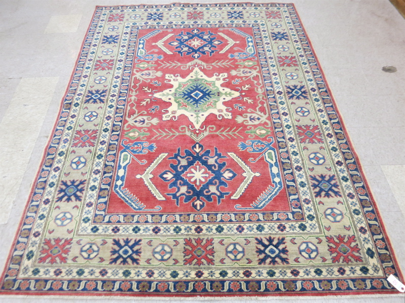 Appraisal: HAND KNOTTED ORIENTAL CARPET Pakistani Caucasian triple medallion and stylized