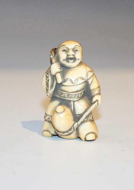 Appraisal: A JAPANESE IVORY NETSUKE in the form of a boy