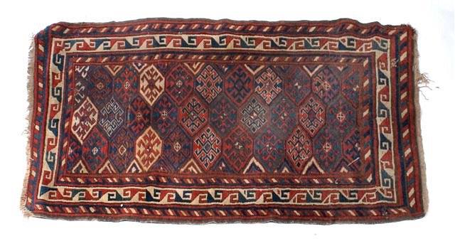 Appraisal: A CAUCASIAN RED AND BLUE RUG with geometric decoration stylised