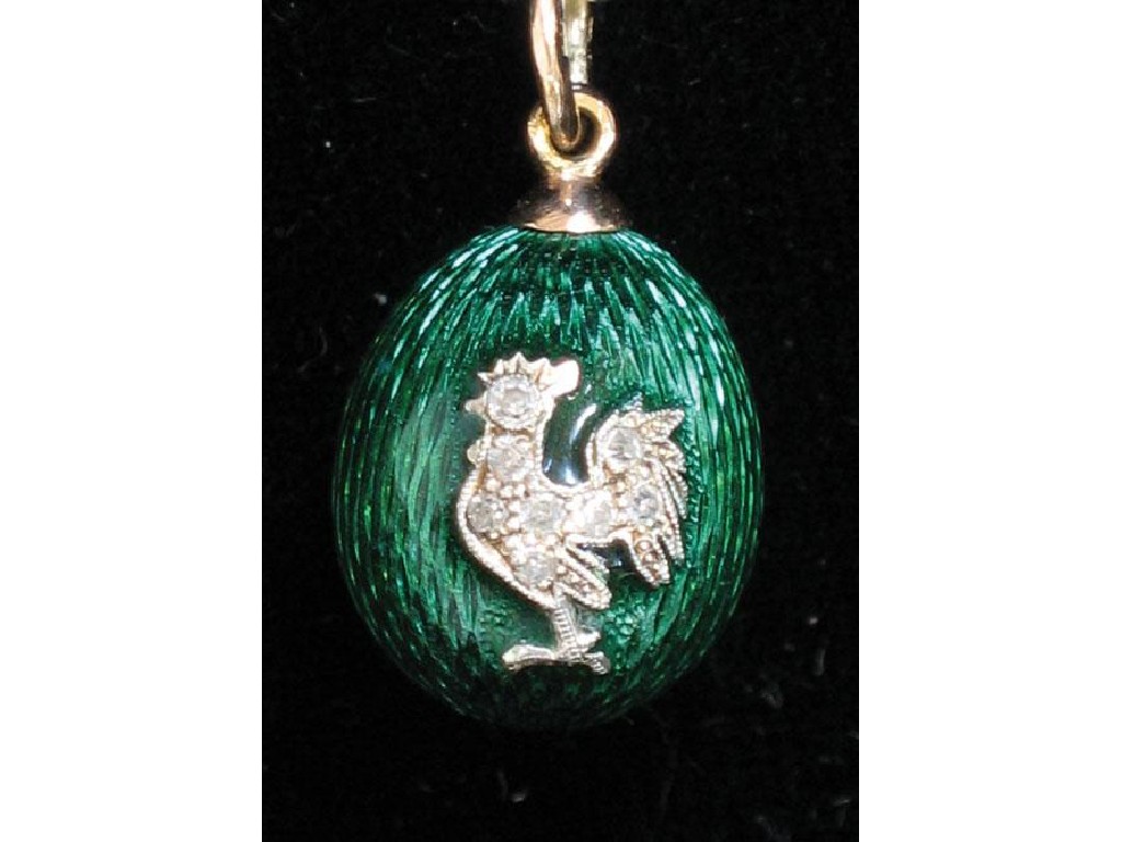 Appraisal: A MINIATURE GREEN GUILLOCHE ENAMELLED EGG in the manner of