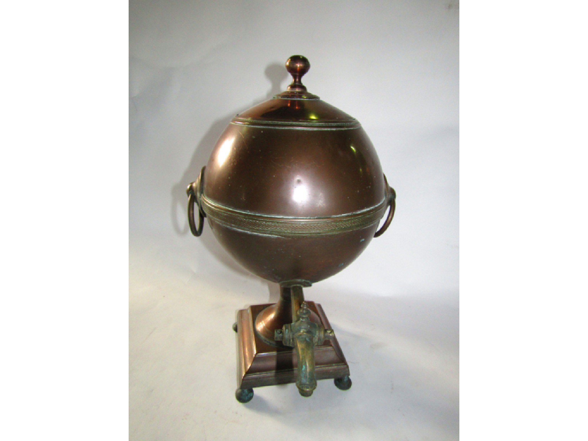 Appraisal: An antique copper samovar of globular form looping handles and