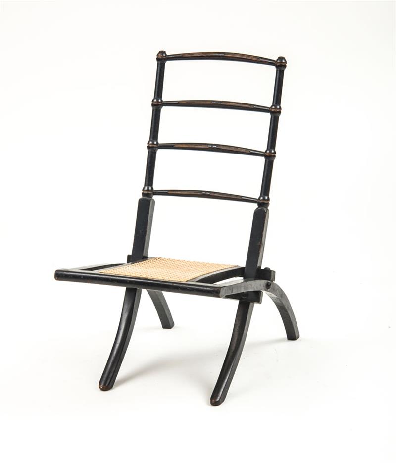 Appraisal: ENGLISH AESTHETIC MOVEMENT EBONIZED FOLDING CHAIR IN THE MANNER OF