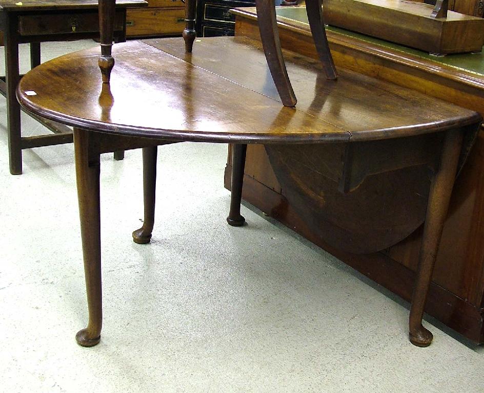 Appraisal: George III oval mahogany drop leaf dining table upon tapered