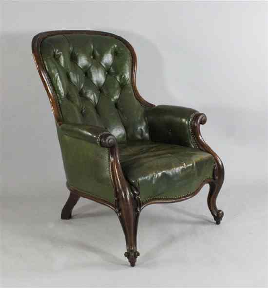 Appraisal: A Victorian carved walnut library chair with button back green