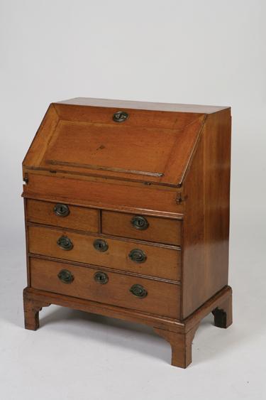 Appraisal: A GEORGE II OAK BUREAU with a sloping fall enclosing