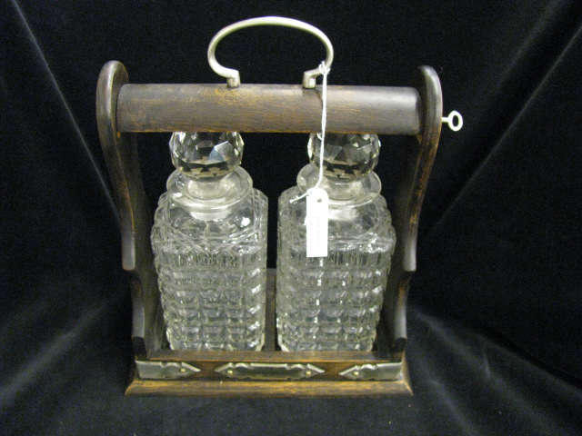 Appraisal: English Double Decanter Tantilus locking wood holder silverplate trim block