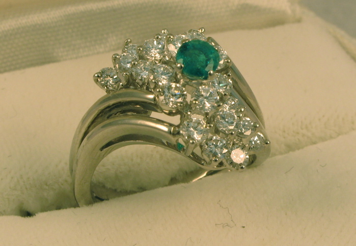 Appraisal: EMERALD DIAMOND AND EIGHTEEN KARAT WHITE GOLD RING set with