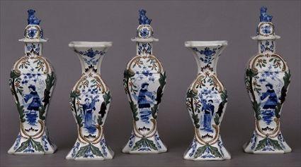 Appraisal: DUTCH DELFT MOLDED POLYCHROME FIVE-PIECE GARNITURE Comprising angular baluster-form vases