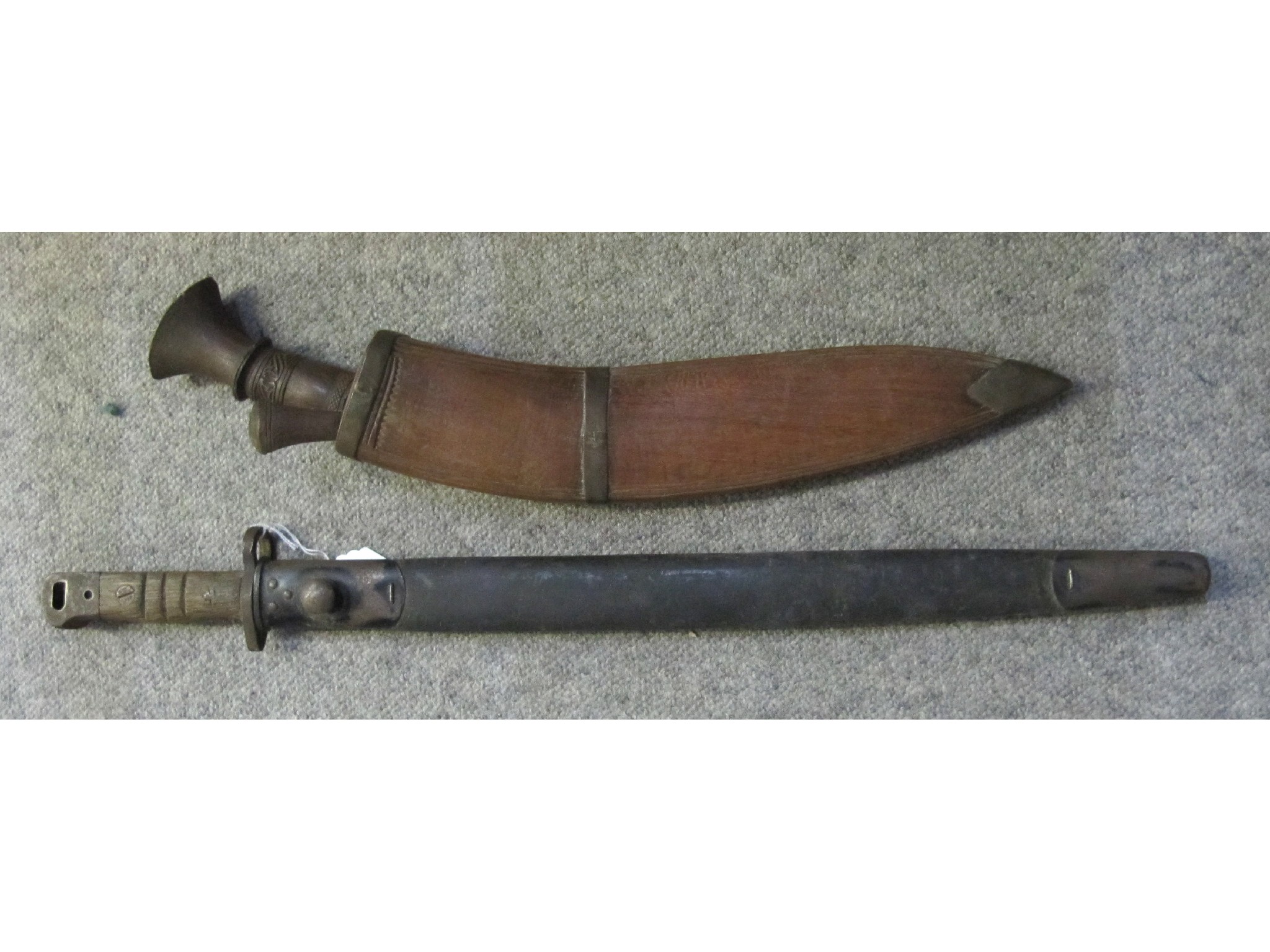 Appraisal: A lot comprising a bayonet in scabbard and a kukri