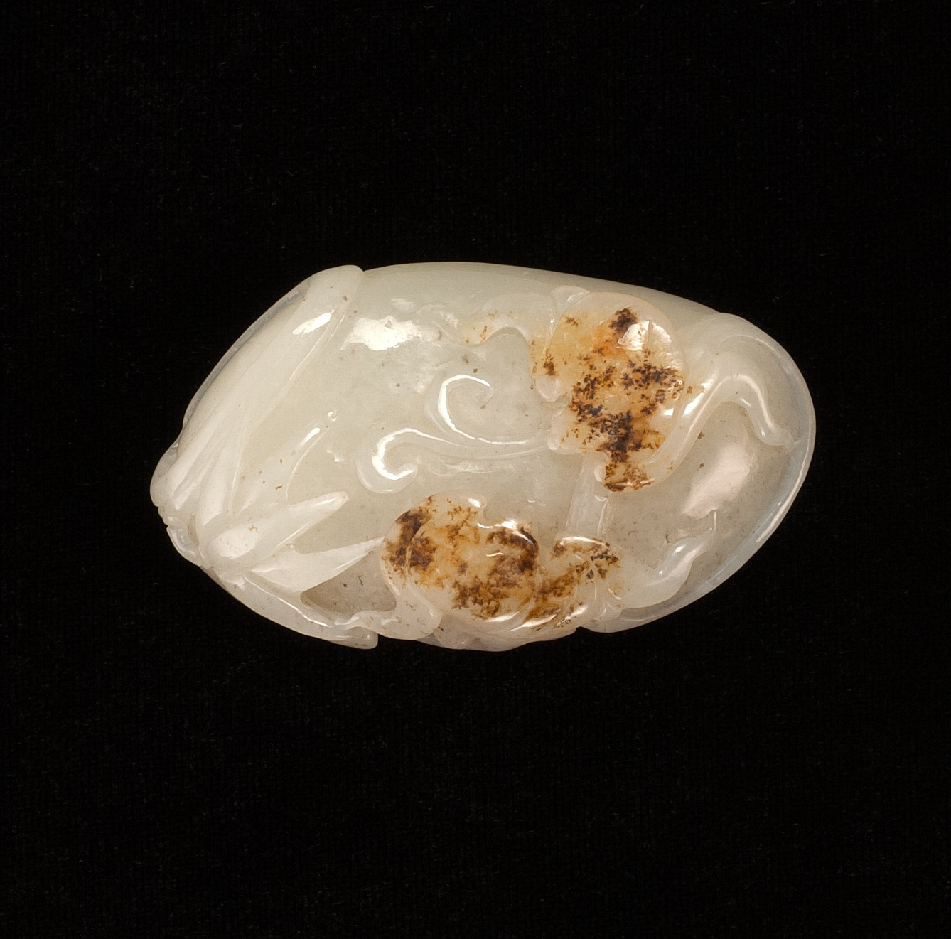 Appraisal: RUSSET AND WHITE JADE PENDANT In the form of a