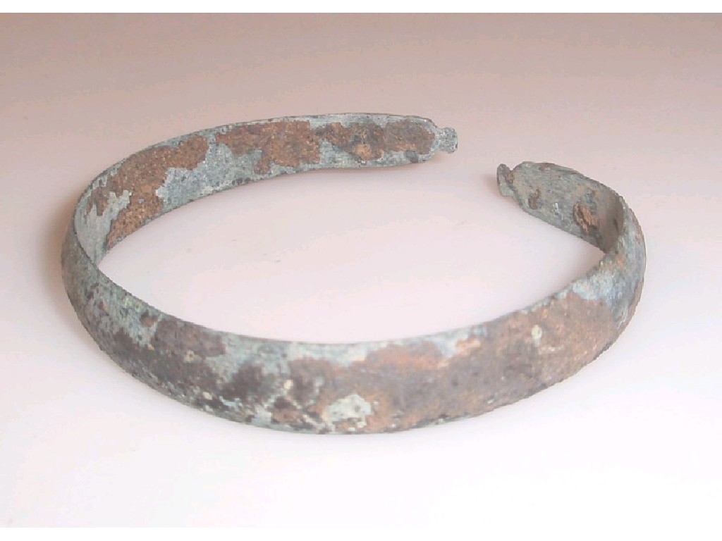 Appraisal: A late Roman flattened bronze open-ended bracelet with triangular-shaped terminals