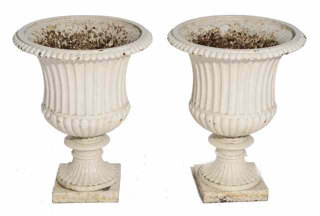 Appraisal: A PAIR OF VICTORIAN CAST IRON GARDEN URNS of classical