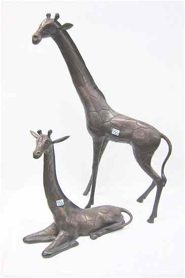 Appraisal: TWO BRONZE WILDLIFE SCULPTURES two African giraffe standing and recumbent