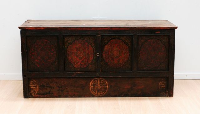 Appraisal: A Tibetan low cabinet of four panels raised design created