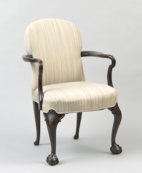 Appraisal: A Carved Arm Chair A traditionally styled arm chair with