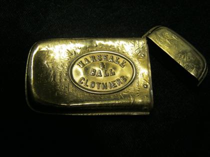 Appraisal: Gold matches caseLow karat gold with 'Marshall Ball Clothers' logo