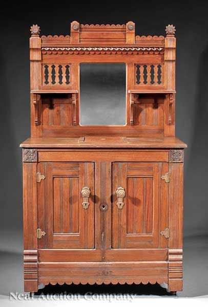 Appraisal: A Late Victorian Walnut Icebox c mirrored back with rosette