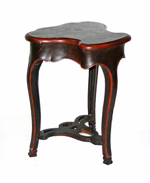 Appraisal: A Rococo style ebonized and lacquered cartouche shaped table height