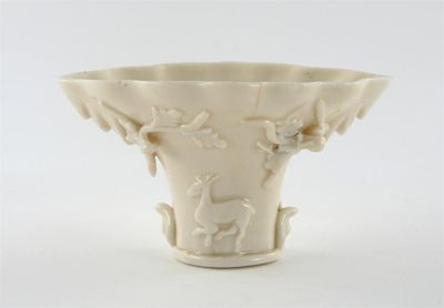 Appraisal: A Chinese blanc de Chine libation cup moulded and applied