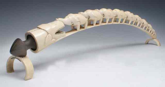 Appraisal: A CARVED IVORY TUSK in the form of a chain