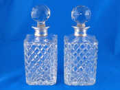 Appraisal: A pair of silver mounted hobnail cut glass square decanters