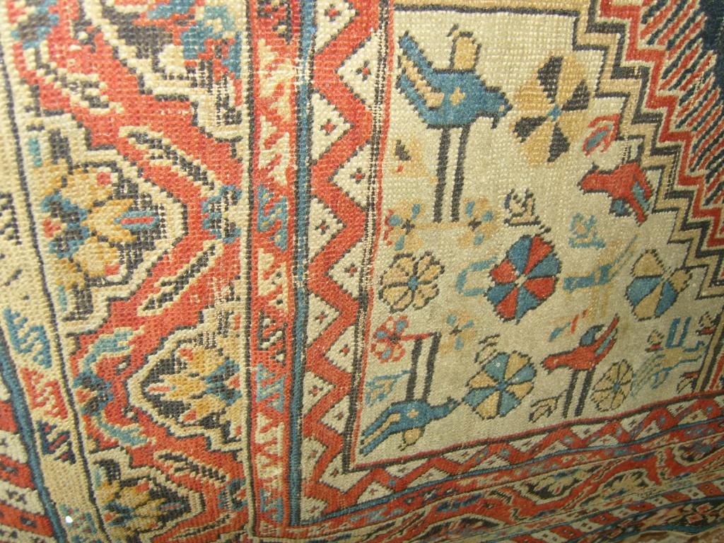 Appraisal: A blue ground eastern wool rug with stylised animal geometric