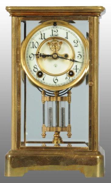 Appraisal: Brass Glass Ansonia Clock Description Time and strike Works well