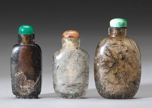 Appraisal: Three hair crystal snuff bottles On of dark 'tea' hue