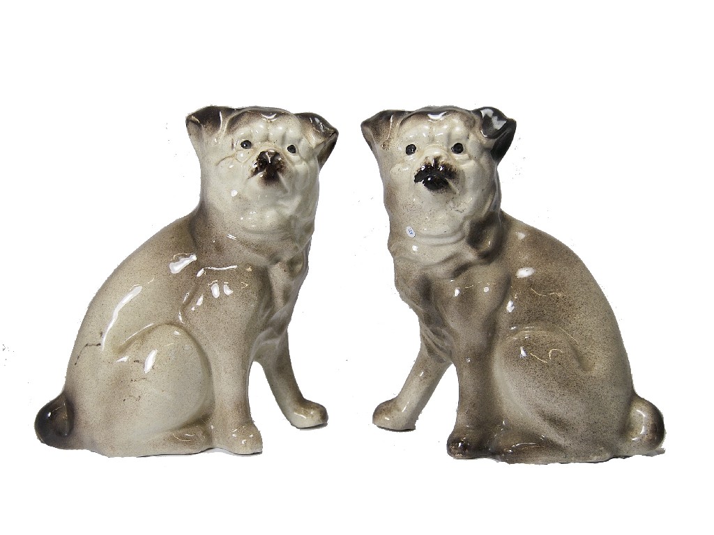 Appraisal: A pair of Staffordshire-style pottery seated pug dogs cm