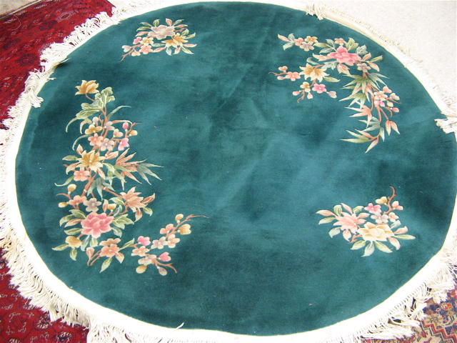 Appraisal: ROUND CHINESE AREA RUG with four clusters of colorful flowers