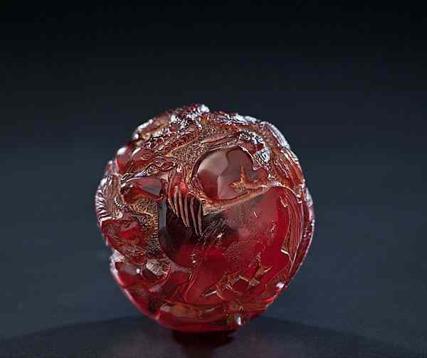 Appraisal: Chinese Amber Zodiac Ball Chinese a carved amber ball with