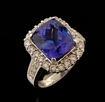 Appraisal: A tanzanite and diamond cluster ring The cushion cut tanzanite