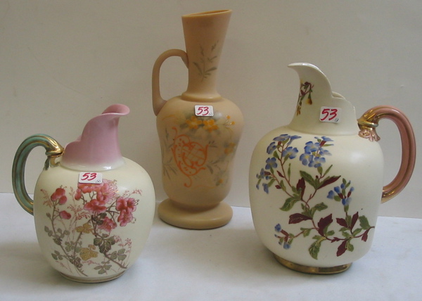 Appraisal: THREE DECORATED PORCELAIN AND BRISTOL GLASS EWERS The largest having