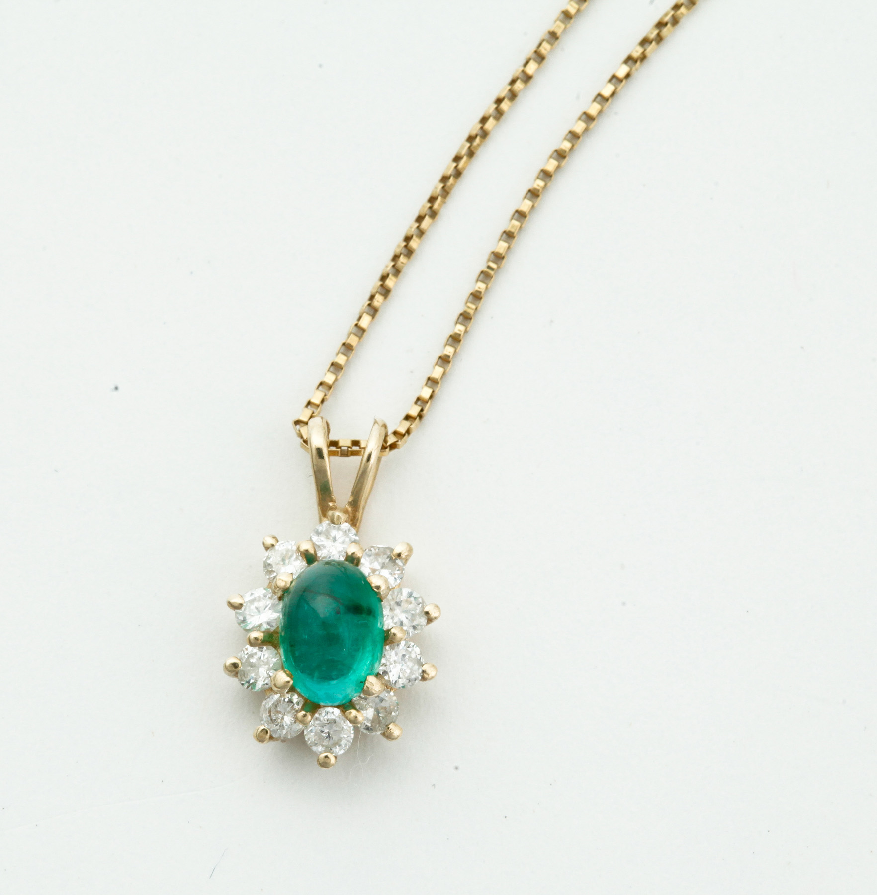 Appraisal: EMERALD AND DIAMOND PENDANT American th century Yellow gold pendant