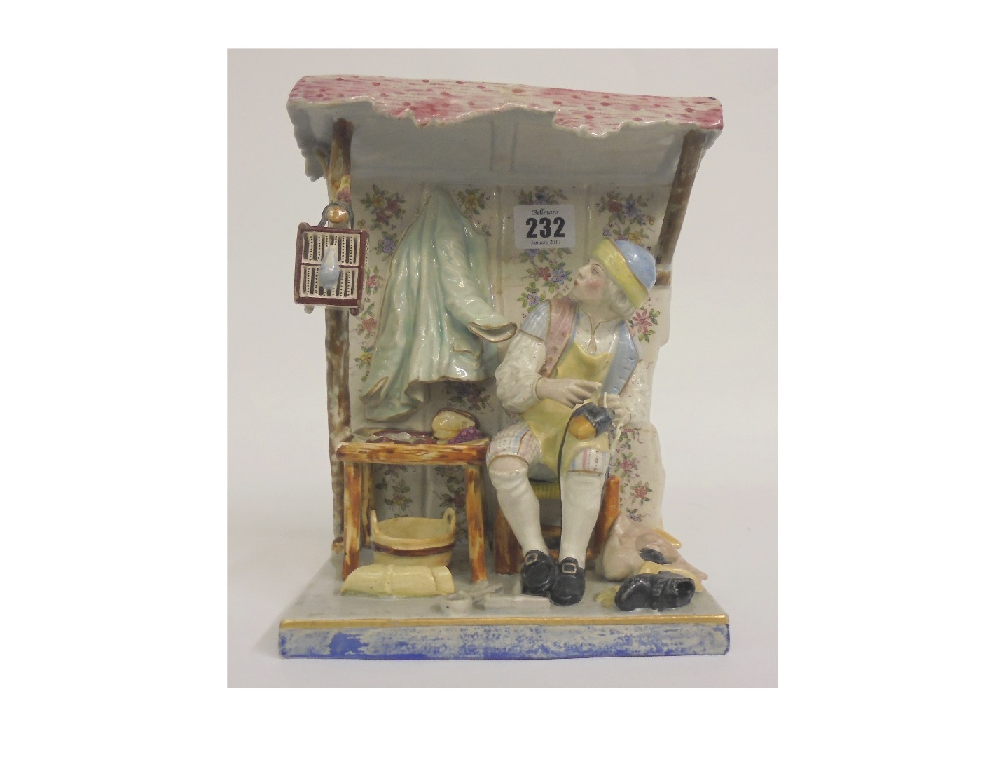 Appraisal: A Faience figure of a shoe mender at work in