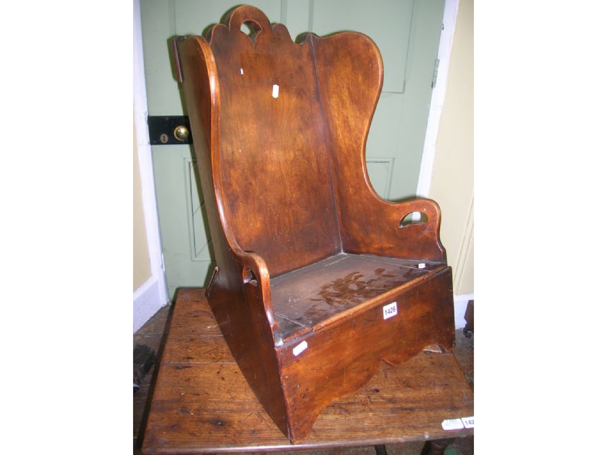 Appraisal: A Georgian child's rocking chair principally in fruitwood the solid