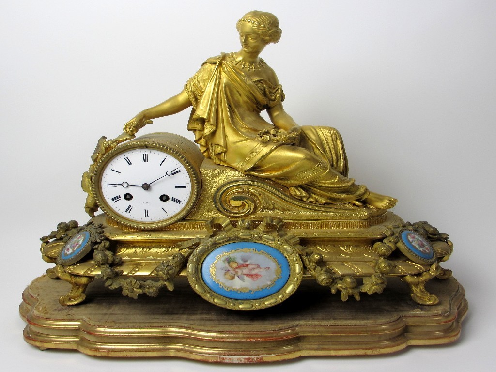 Appraisal: A French gilt metal mantle clock cast with a female