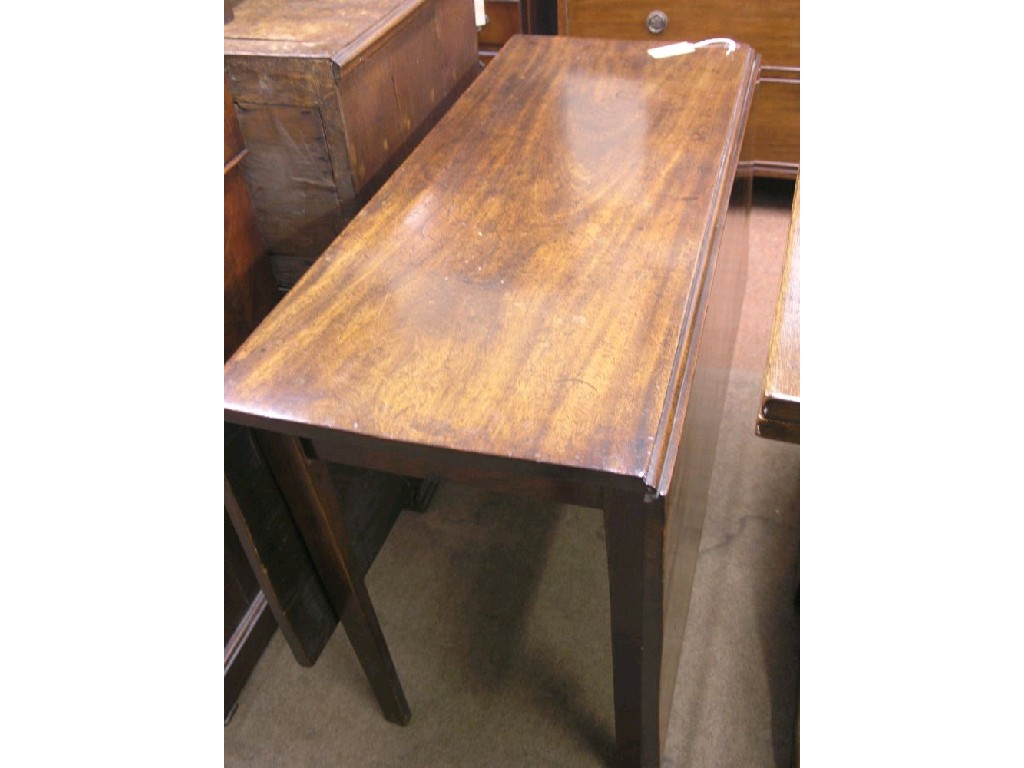 Appraisal: A George III mahogany drop-leaf dining table on square legs