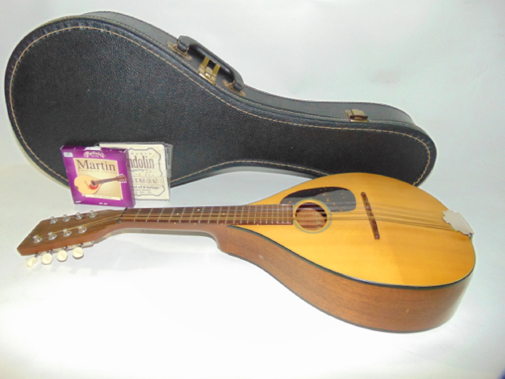 Appraisal: A Martin Company contemporary cased eight string mandolin stamped to