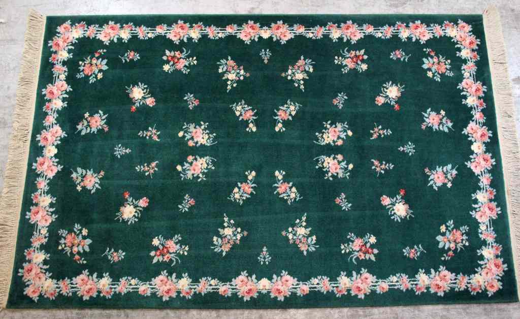 Appraisal: Floral Oriental Wool CarpetOverall floral multi-colored decoration on green ground