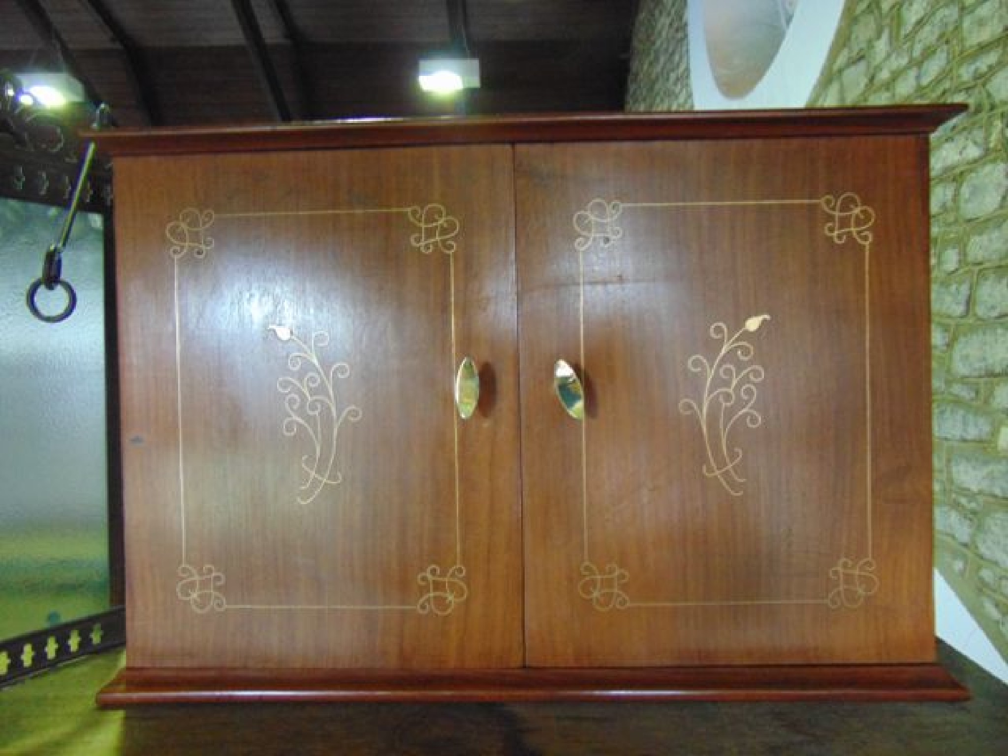 Appraisal: A teak wood smoker's cabinet of rectangular form with brass