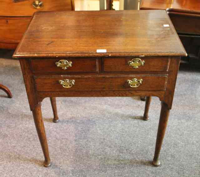 Appraisal: A GEORGIAN OAK LOWBOY fitted with one long two short