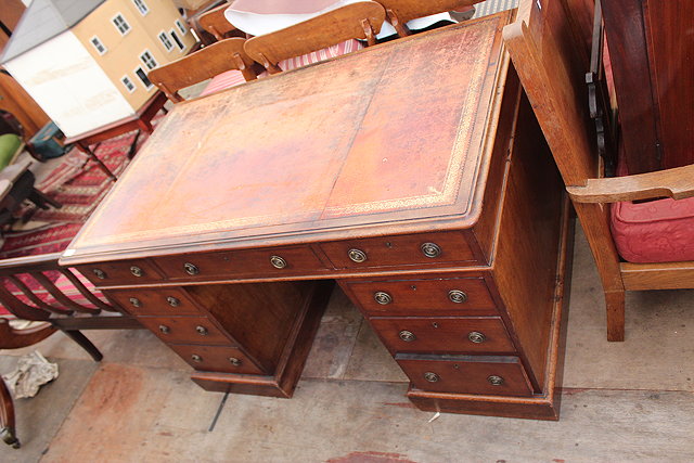 Appraisal: A VICTORIAN MAHOGANY PEDESTAL DESK red leather inset top over