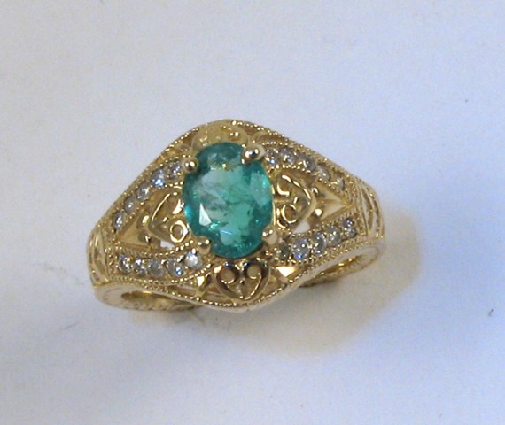 Appraisal: EMERALD AND FOURTEEN KARAT GOLD RING centering an oval-cut green