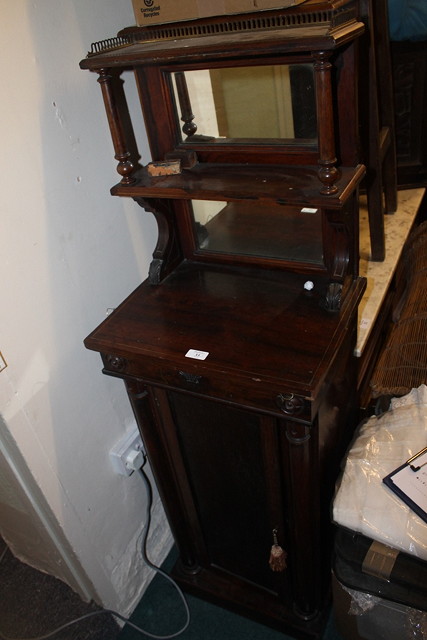 Appraisal: A REGENCY ROSEWOOD CABINET enclosed by single panel door the